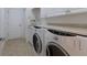 Laundry room featuring a full-size washer and dryer, and storage at 8861 17Th Avenue Nw Cir, Bradenton, FL 34209