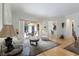 Bright and airy living room featuring hardwood floors, comfortable furniture, and a view into the open kitchen and dining area at 8861 17Th Avenue Nw Cir, Bradenton, FL 34209