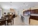 Spacious, open-concept living area featuring a kitchen with bar seating, dining space, and a cozy living room at 8861 17Th Avenue Nw Cir, Bradenton, FL 34209