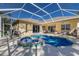 Screened pool with a spa, outdoor seating, and landscaped backyard at 8861 17Th Avenue Nw Cir, Bradenton, FL 34209