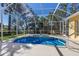 Covered pool with spa, manicured lawn, and comfortable lounge chairs at 8861 17Th Avenue Nw Cir, Bradenton, FL 34209