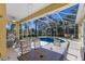 Enclosed pool and patio with lounge chairs and dining table at 8861 17Th Avenue Nw Cir, Bradenton, FL 34209