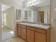 Bathroom features a double sink vanity with a large mirror and ceramic tile flooring at 8996 Excelsior Loop, Venice, FL 34293