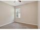 Cozy bedroom offers carpeted floors, a ceiling fan, and a window for natural light at 8996 Excelsior Loop, Venice, FL 34293