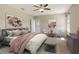 Staged bedroom is adorned with warm colors, artwork and stylish furnishings at 8996 Excelsior Loop, Venice, FL 34293