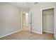 An inviting bedroom with neutral carpet and a doorway to an adjoining room and closet at 8996 Excelsior Loop, Venice, FL 34293