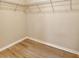Walk-in closet features wooden laminate floors and shelving for optimal storage at 8996 Excelsior Loop, Venice, FL 34293