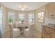 Cozy breakfast nook with a round table set in front of a bay window offering ample natural light at 8996 Excelsior Loop, Venice, FL 34293