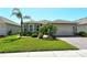 Charming single-story home featuring well-manicured landscaping and a brick driveway leading to a two-car garage at 8996 Excelsior Loop, Venice, FL 34293