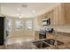 Modern kitchen featuring stainless steel appliances, granite countertops, and ample cabinet space at 8996 Excelsior Loop, Venice, FL 34293