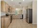 Bright kitchen features wood-look cabinets, stainless steel appliances, and granite countertops at 8996 Excelsior Loop, Venice, FL 34293