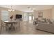 Comfortable living room featuring neutral tones, tile flooring, and plenty of natural light at 8996 Excelsior Loop, Venice, FL 34293
