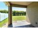 Outdoor patio overlooking a lush green lawn and privacy landscaping at 8996 Excelsior Loop, Venice, FL 34293