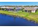 Aerial view of houses with screened-in lanais overlooking a lake in a beautiful residential neighborhood at 1014 Calico Gln, Bradenton, FL 34212