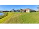 Spacious backyard featuring a serene lake view and lush green lawn that enhances the property's appeal at 1014 Calico Gln, Bradenton, FL 34212