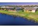 Backyard water view of neighboring homes with screened in patios at 1014 Calico Gln, Bradenton, FL 34212