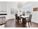 Bright dining area with contemporary light fixture and window views, creating a welcoming space at 1014 Calico Gln, Bradenton, FL 34212