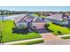 Inviting single-Gathering home features a brick driveway, lush lawn, and well-maintained landscaping near a lake at 1014 Calico Gln, Bradenton, FL 34212