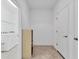 Hallway provides access to the laundry area with a side cabinet for storage, and doors to the other rooms at 1014 Calico Gln, Bradenton, FL 34212