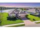 Aerial front view of house with meticulous landscaping and a brick driveway at 1014 Calico Gln, Bradenton, FL 34212