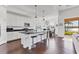 Kitchen with white cabinets, black countertops, stainless steel appliances and island with seating at 1014 Calico Gln, Bradenton, FL 34212