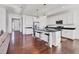 Bright kitchen with stainless steel appliances, white cabinets, black countertops, and a large island at 1014 Calico Gln, Bradenton, FL 34212