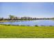 Wide angle view of the beautiful lake and lush green lawn, surrounded by trees, perfect for relaxing and enjoying the scenery at 1014 Calico Gln, Bradenton, FL 34212