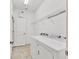 Functional laundry room featuring a washer, dryer, storage shelf and white walls at 1014 Calico Gln, Bradenton, FL 34212