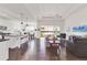 Bright, open-concept living space with wood floors, ample seating, and sliding doors leading to the outdoors at 1014 Calico Gln, Bradenton, FL 34212
