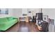 Bright living room offers a comfy sofa, a study desk and hardwood floors at 1014 Calico Gln, Bradenton, FL 34212