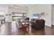 Bright and airy living space featuring wood floors, comfortable seating, and scenic views from the large sliding doors at 1014 Calico Gln, Bradenton, FL 34212