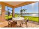 Inviting screened patio providing views of the lake and surrounding greenery; great for relaxing outdoors at 1014 Calico Gln, Bradenton, FL 34212