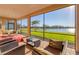 Relaxing screened patio with comfortable seating and views of the serene lake and landscaped backyard at 1014 Calico Gln, Bradenton, FL 34212
