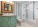 Well-lit bathroom with a colorful vanity, mirror, and enclosed shower at 110 10Th S St, Bradenton Beach, FL 34217