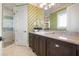 Bathroom features a large vanity with stone counters, decorative wallpaper and a glass walk-in shower at 110 10Th S St, Bradenton Beach, FL 34217
