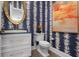 Powder room with custom wallpaper and decorative accents at 110 10Th S St, Bradenton Beach, FL 34217
