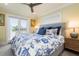 Bedroom features nautical themed bedding, hardwood floors and balcony access to enjoy the view at 110 10Th S St, Bradenton Beach, FL 34217