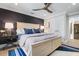 Comfortable bedroom featuring a ceiling fan and a blue accent wall at 110 10Th S St, Bradenton Beach, FL 34217