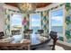 Dining room featuring tropical wallpaper and water view from large windows at 110 10Th S St, Bradenton Beach, FL 34217