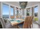 Light-filled dining room with views of the water and stylish chandelier at 110 10Th S St, Bradenton Beach, FL 34217