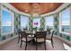 Bright dining room with tropical wallpaper, water view and decorative chandelier at 110 10Th S St, Bradenton Beach, FL 34217