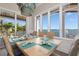 Dining room with large windows providing natural light and views of the water at 110 10Th S St, Bradenton Beach, FL 34217