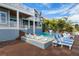 A stunning backyard featuring a pool, boat dock, and manicured lawn, perfect for luxurious outdoor living and entertainment at 110 10Th S St, Bradenton Beach, FL 34217