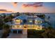 Elegant two-story home with a waterfront view, rooftop deck and multiple balconies at sunset at 110 10Th S St, Bradenton Beach, FL 34217