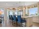 Kitchen features seating at island, stainless appliances, designer backsplash, and white cabinetry at 110 10Th S St, Bradenton Beach, FL 34217