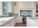 Gourmet kitchen boasts stainless oven, white cabinets, tiled backsplash, and granite countertops at 110 10Th S St, Bradenton Beach, FL 34217