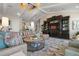 This large living room features sophisticated decor, built-in shelving, vaulted ceilings, and comfortable seating at 110 10Th S St, Bradenton Beach, FL 34217
