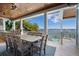 Outdoor dining area featuring a tiled floor, ceiling fans, and views of the pool and waterfront at 110 10Th S St, Bradenton Beach, FL 34217