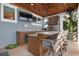 Outdoor kitchen features built-in grill, mini fridge, and bar seating at 110 10Th S St, Bradenton Beach, FL 34217