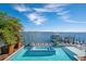 Relaxing pool and spa overlooking stunning water views create a serene and luxurious outdoor living space at 110 10Th S St, Bradenton Beach, FL 34217